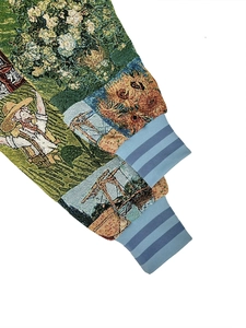 Close-up of vintage floral embroidery on jacket sleeve with blue ribbed elastic cuff