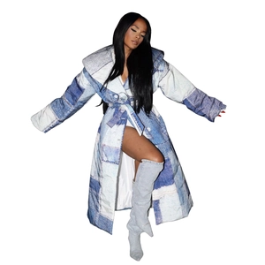 Detail of long quilted denim coat with patch print design and matching waist belt tie