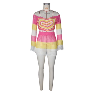 Detailed knit texture of crochet two-piece set with pink stripes and heart pattern