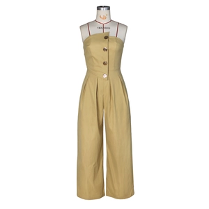 Detail of khaki strapless jumpsuit featuring decorative gold buttons and wide-leg cut