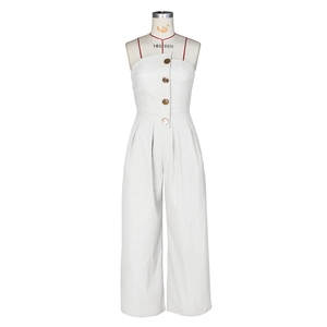 Detail of four golden decorative buttons on white strapless wide-leg jumpsuit
