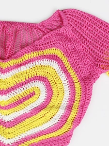 Detail of pink hand-crocheted top featuring a colorful heart pattern and knit texture