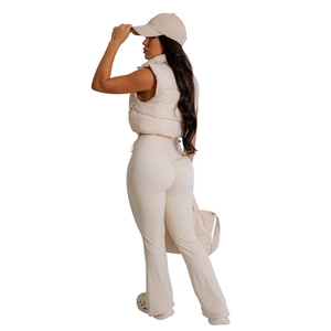 Detail view of cream quilted puffer vest paired with high-waisted lift leggings set