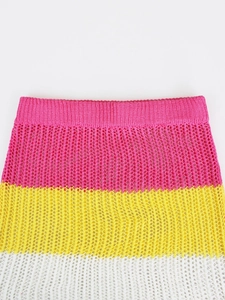 Close-up of three-color crochet skirt with pink rib waist and hollow mesh texture