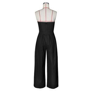 Detail view of back zipper closure and pleated waist on black strapless jumpsuit