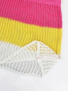 Detail of colorful striped hollow knit fabric with pink, yellow and beige crochet texture