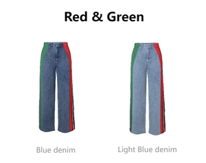 Detail view of high-waisted wide-leg denim pants with red and green side stripes