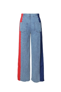 Detail view of high waist jeans with red and blue striped side panels and elastic waistband