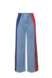 Detail view of high-waist wide leg jeans featuring side stripes and tricolor patchwork design