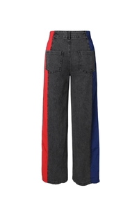 Detail view of high waist wide leg jeans featuring red and blue side contrast stitching