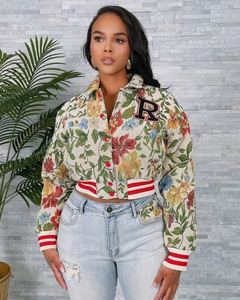 Detailed close-up of floral jacquard jacket with red buttons and embroidered letter R