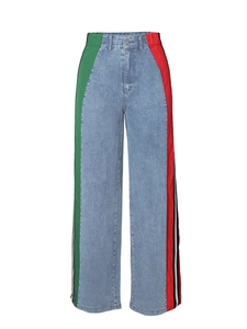 Detail of high waist wide leg jeans featuring red and green side panels with striped trim