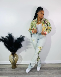 Detail of floral printed short jacket with R letter patch and matching ripped jeans