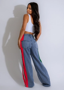 Detail of high-waist jeans showing side stripes in red, white and black for sporty look