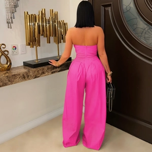 Back view of hot pink strapless jumpsuit featuring hidden zipper and wide-leg cut