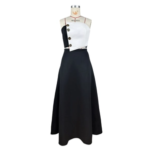 Detail of color-block tube top with gold buttons and high-waist A-line maxi skirt set