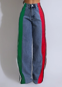 Detail of high-waisted denim pants featuring vertical red and green side stripe panels