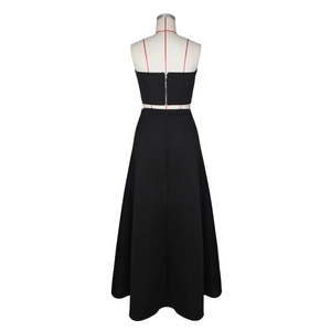 Detail view of the metallic back zipper on a black tube top and elegant A-line long skirt set