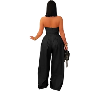 Detail view showing the back zipper closure and waist pleats of the strapless black jumpsuit