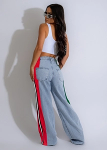 Detailed view of light blue wide leg jeans featuring vibrant side stripe webbing trim