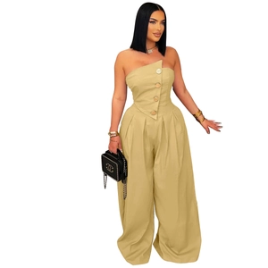 Detail of khaki bandeau jumpsuit with gold buttons and asymmetric folded neckline