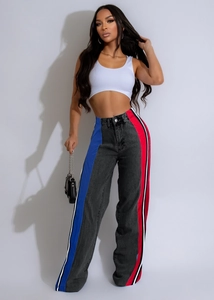 Detail view of high-waist straight jeans with contrast stripes and color blocking panels