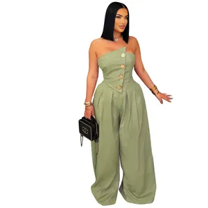 Detail of sage green strapless jumpsuit featuring decorative vintage gold buttons on top