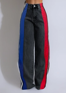 Close-up of women's color block straight jeans with blue and red side panel stripes