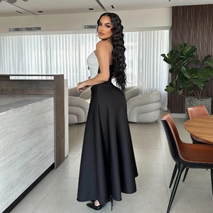Detail of elegant two-piece set with white bandeau top and black high-waisted A-line maxi skirt