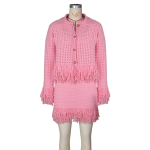Detailed knit texture and pink fringe tassels on a stylish two-piece crochet set