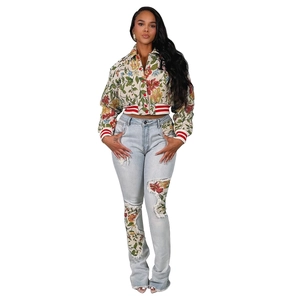 Detailed view of floral bomber jacket with ribbed collar and embroidered letter R patch