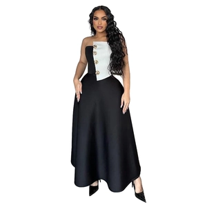 Detail of elegant two-piece set with gold buttons and black and white contrast dress