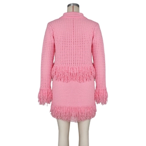 Detailed knit texture and fringe trim on pink crochet cardigan and skirt set