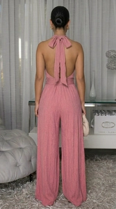 Detailed back view of pink halter neck jumpsuit with wide leg and crinkle fabric texture