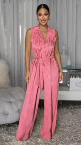 Close-up of pink halter jumpsuit featuring vertical textures and a waist tie detail