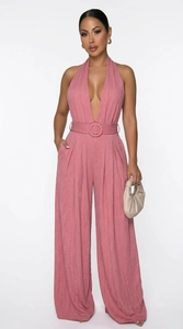 Detail of mauve halter neck jumpsuit featuring textured fabric and matching waist belt