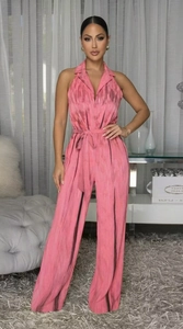 Detail of pink sleeveless halter jumpsuit with textured fabric and waist bow tie