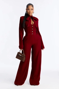 Detail of elegant wine red wide-leg jumpsuit with bow-tie collar and vertical rib texture