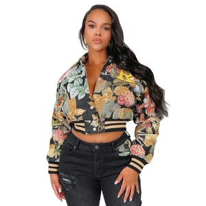 Close-up of floral tapestry jacket featuring a yellow letter R patch and striped ribbed cuffs