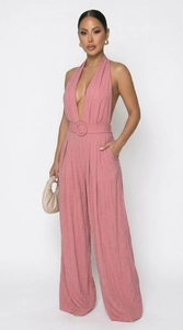 Detail of pink halter neck wide leg jumpsuit with textured fabric and buckled waist belt