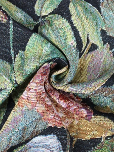 Detailed view of vintage floral tapestry fabric with high density weave and leaf patterns
