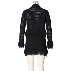 Back view of black crochet two-piece set featuring dense fringe trim on sleeves and hem