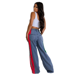 Detail view of high waisted wide leg jeans featuring colorful side stripes on denim