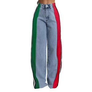 Detail of red and green side stripes on light blue high-waisted wide leg denim jeans