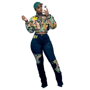 Detailed view of women's floral cropped jacket with letter R patch and ribbed trim