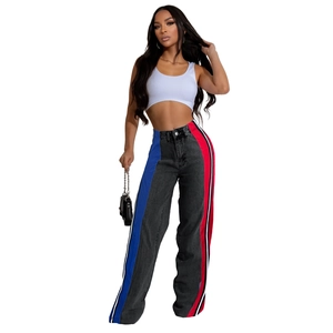 Detail of high waist wide leg jeans with bold blue and red side stripe patchwork design