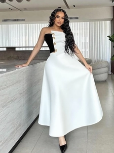 Elegant black and white strapless two-piece dress with gold buttons and A-line skirt