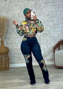 Close-up of vintage print baseball jacket with floral patchwork ripped jeans set