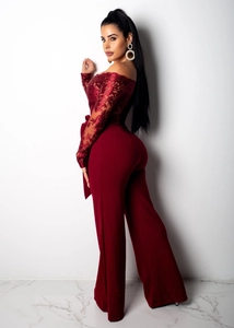 Detail of burgundy off-shoulder lace bodice and elegant wide-leg jumpsuit with waist tie