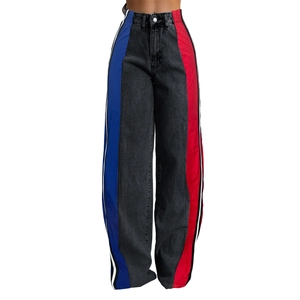 Detailed side view of high-waisted color block jeans with white side stripes and wide legs